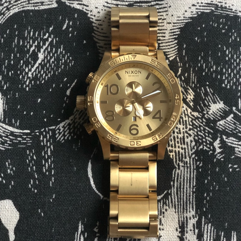 Men’s yellow gold Nixon watch